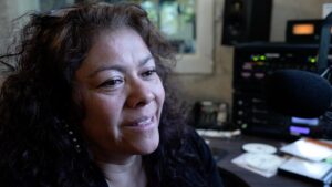 This image features a close-up of WMPG DJ Rosita looking off into the distance.