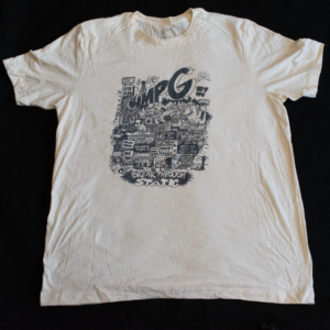 Picture of WMPG T-Shirt on a off-white base with a design of a city with the WMPG logo above it. The shirt is on a black background.