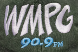 Picture of a closeup of the WMPG logo on the green hat.