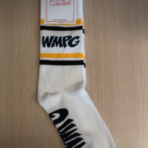 Picture of white socks on a beige background. The socks have stripes in yellow and black alongside the WMPG logo on the ankle part of the sock with the WMPG logo on the bottom.